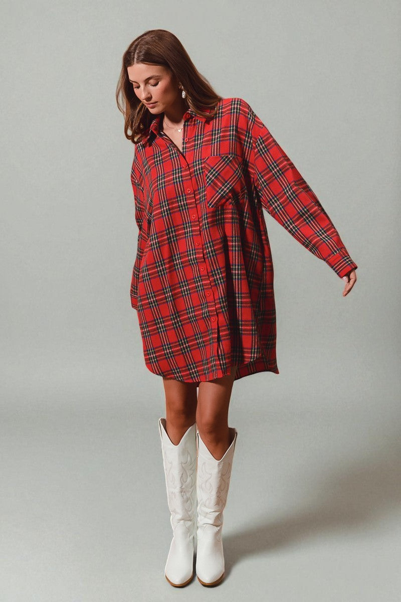 Woman wearing a red plaid dress and white cowboy boots on a gray background