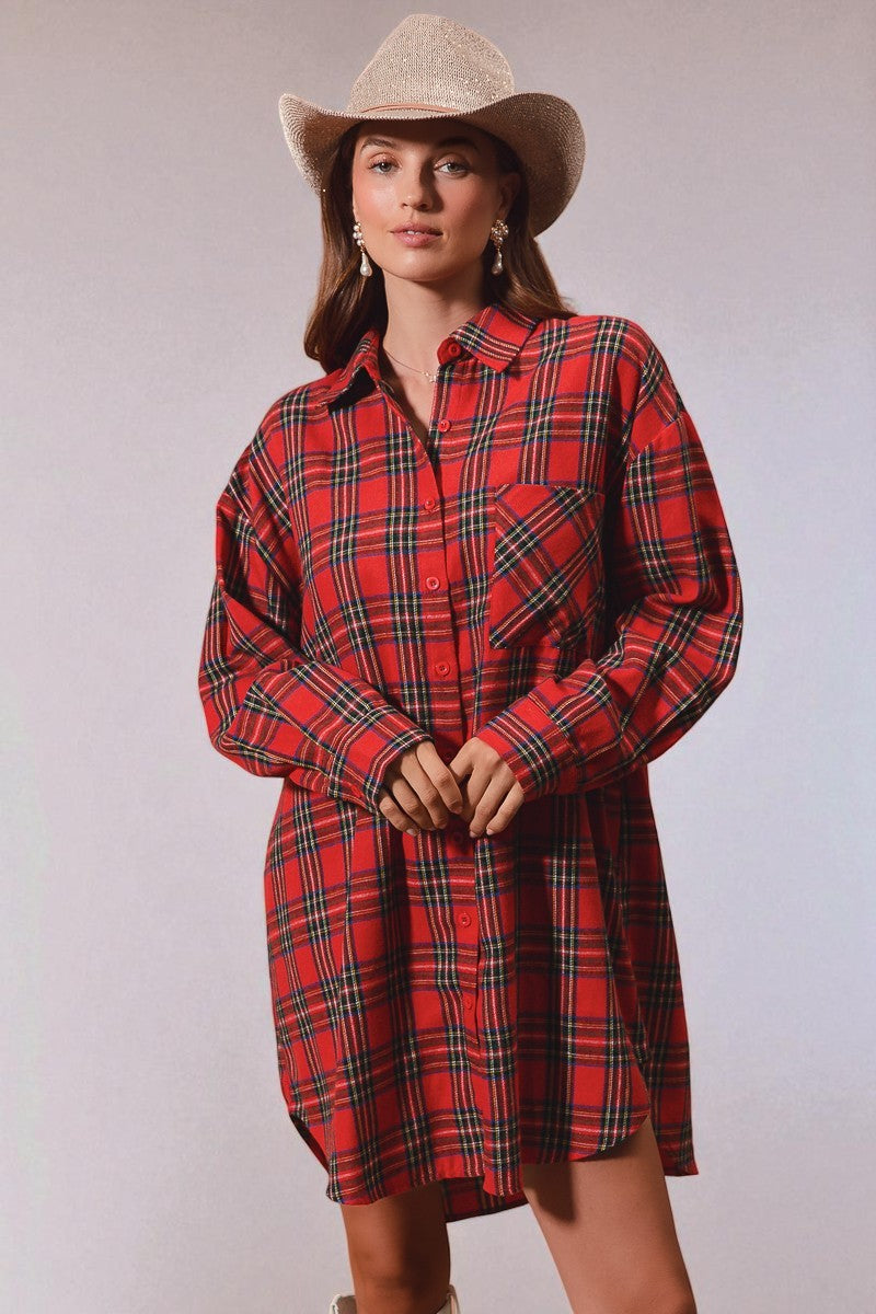 Woman wearing a red plaid dress and cowboy hat against a plain background