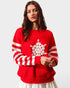 Woman wearing a red sweater with white snowflake design on a plain background