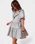 Woman wearing a patterned dress on a white background