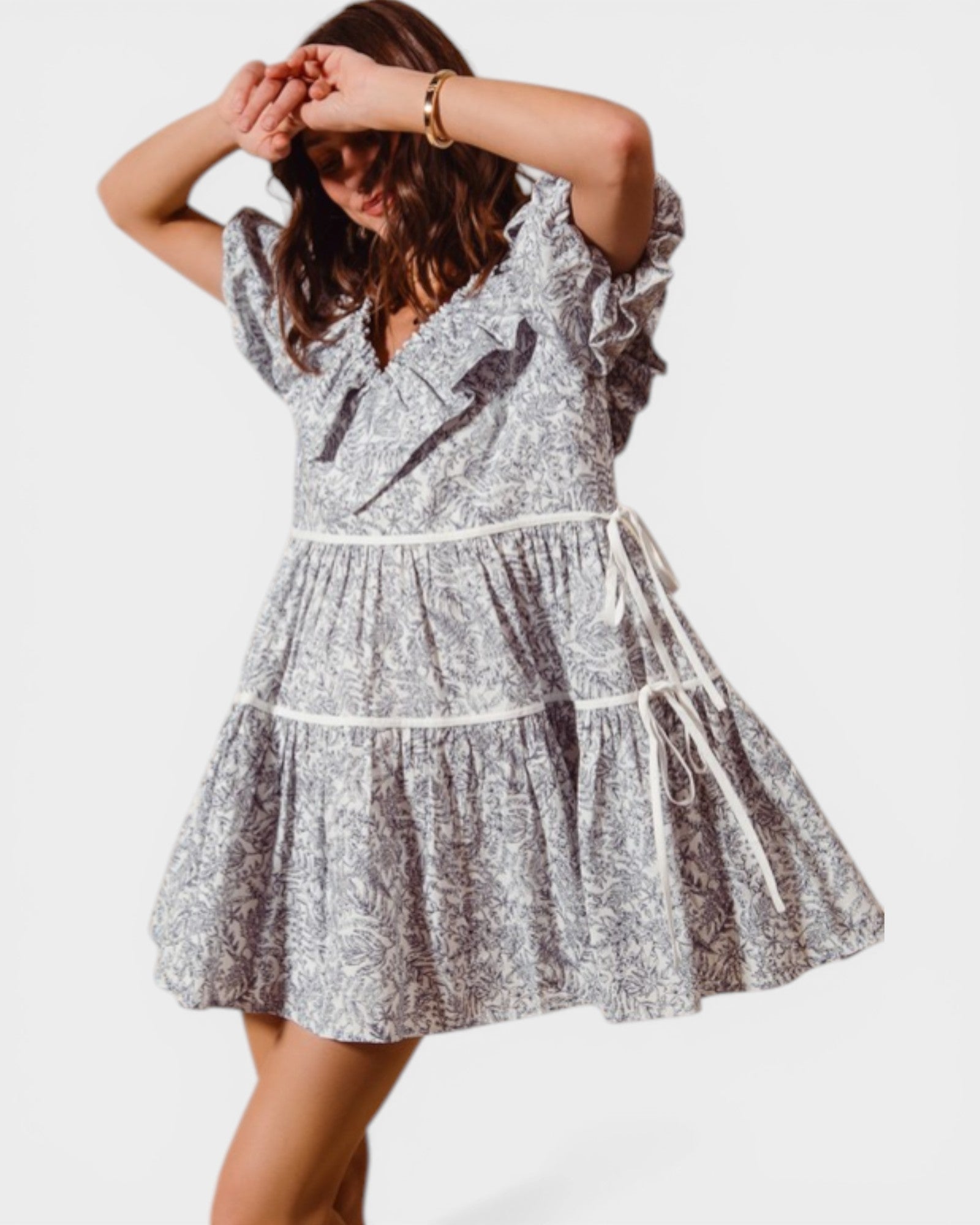 Woman wearing a silver and black patterned dress on a white background