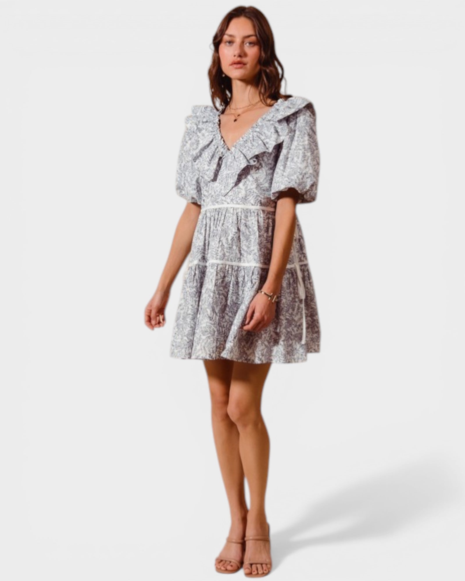 Woman wearing a patterned dress on a white background