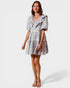 Woman wearing a patterned dress on a white background