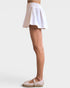 White skirt worn by a person on a plain background