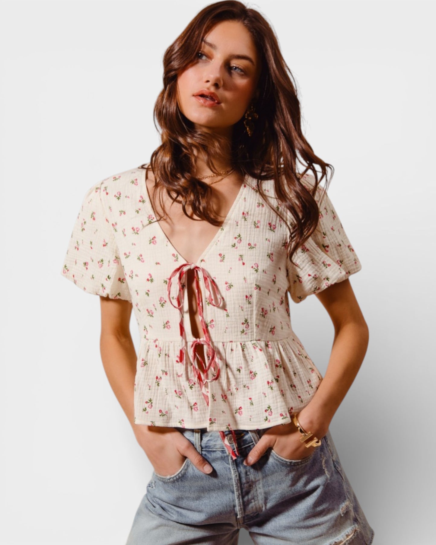 Woman wearing a floral blouse with a plain background