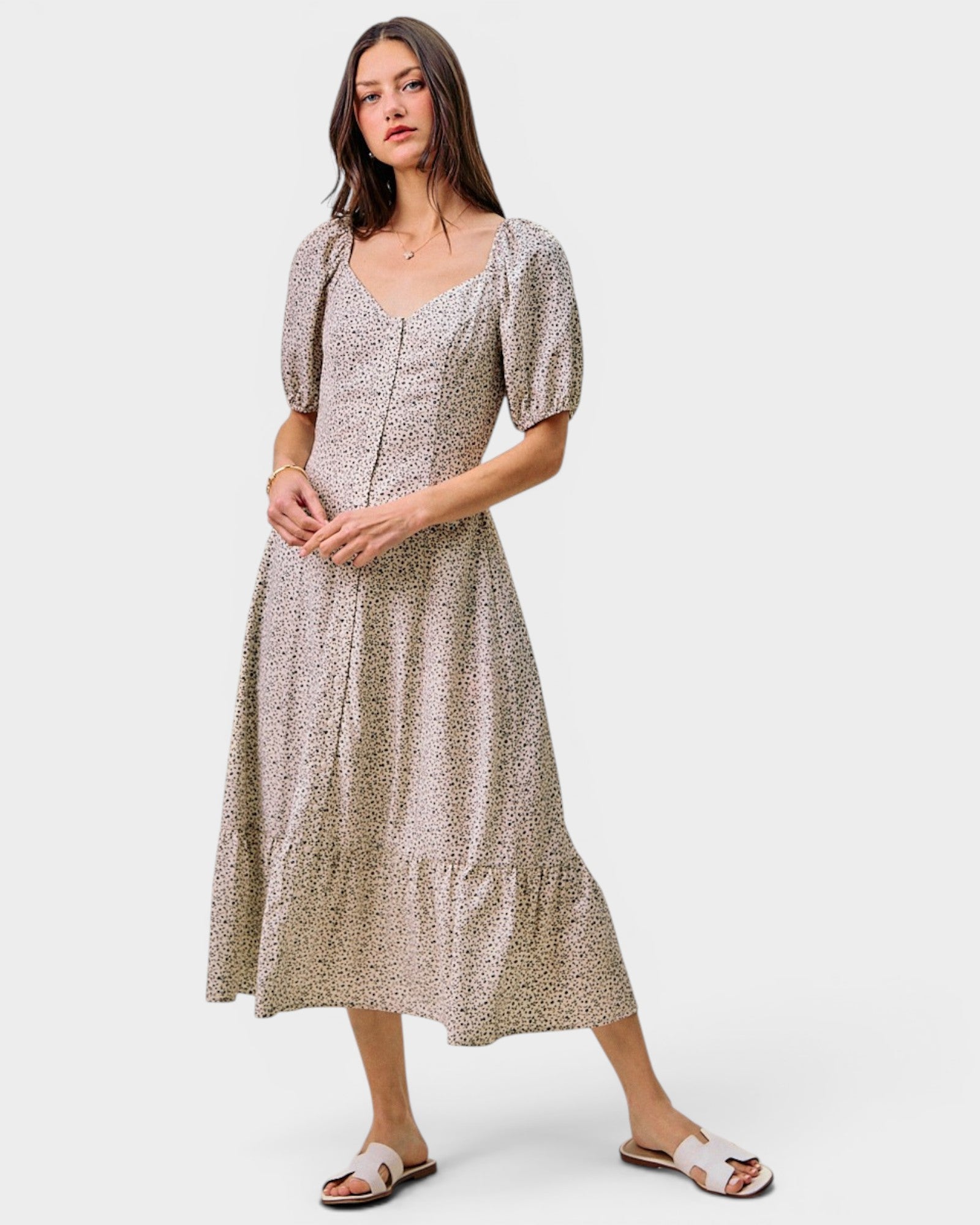 Woman wearing a patterned dress on a white background