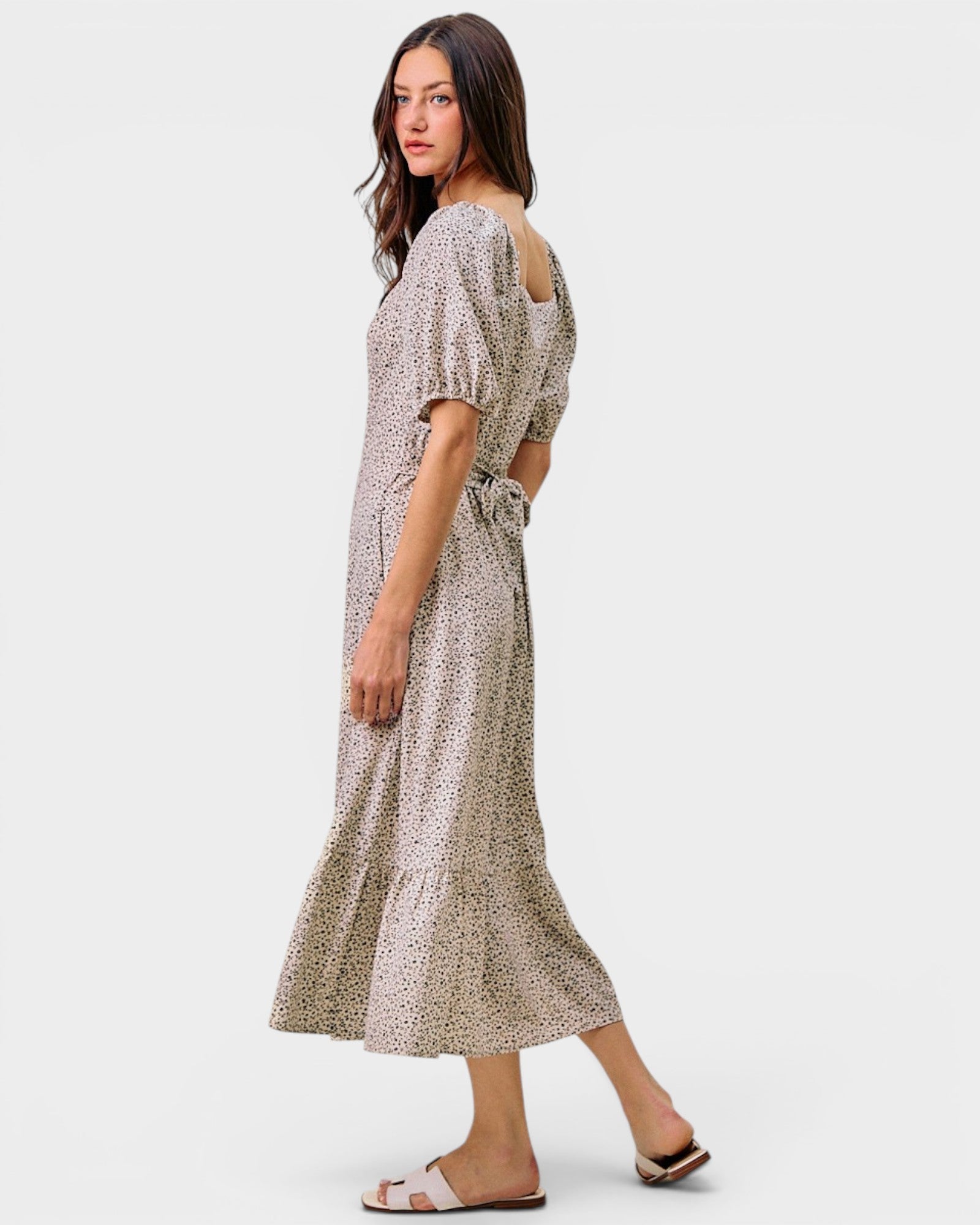 Woman wearing a patterned dress on a white background