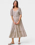 Woman wearing a patterned dress on a white background
