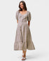 Woman wearing a patterned dress on a white background