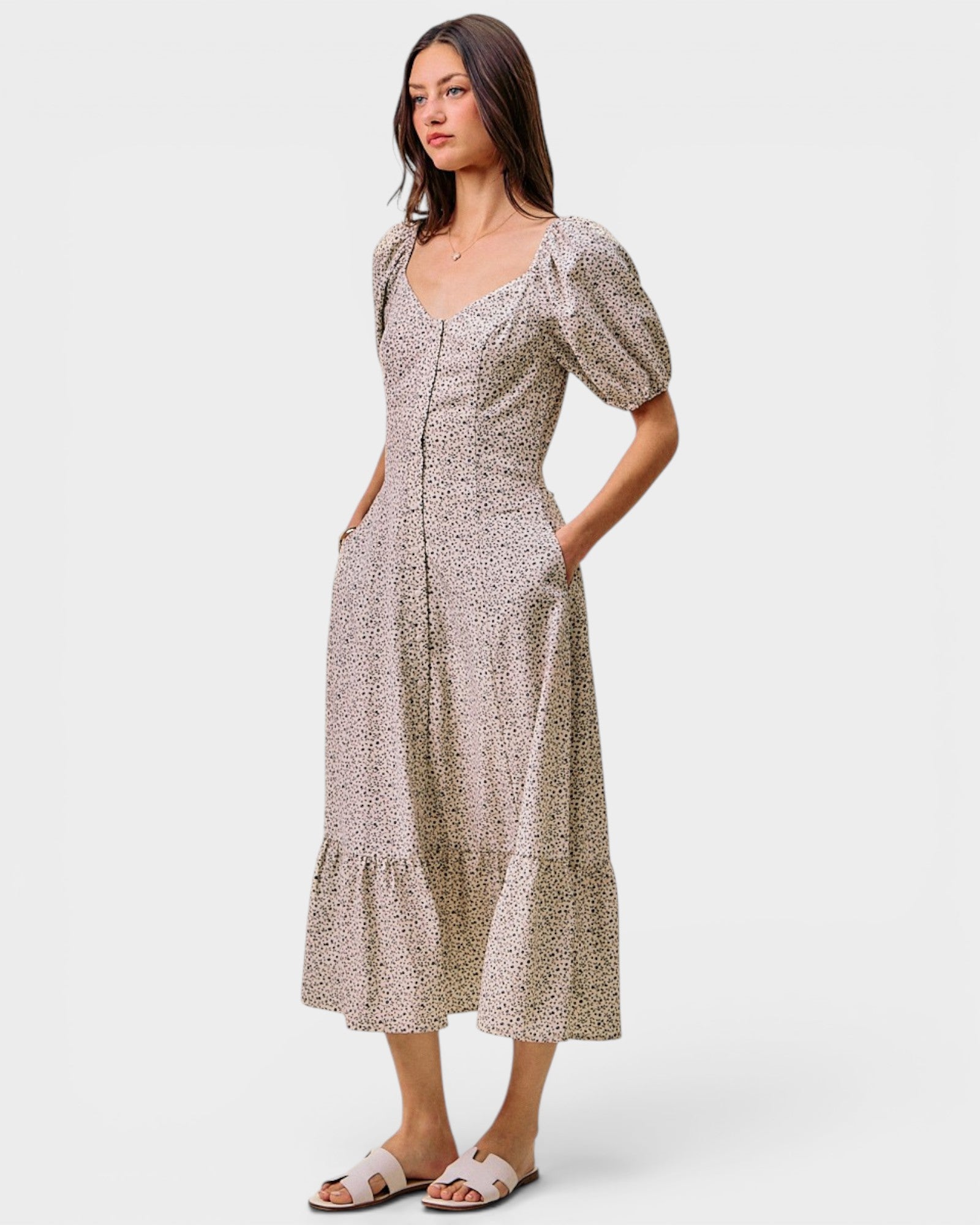 Woman wearing a patterned dress on a white background