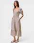 Woman wearing a patterned dress on a white background