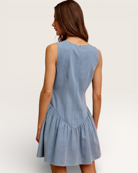 Woman wearing a light blue dress against a white background