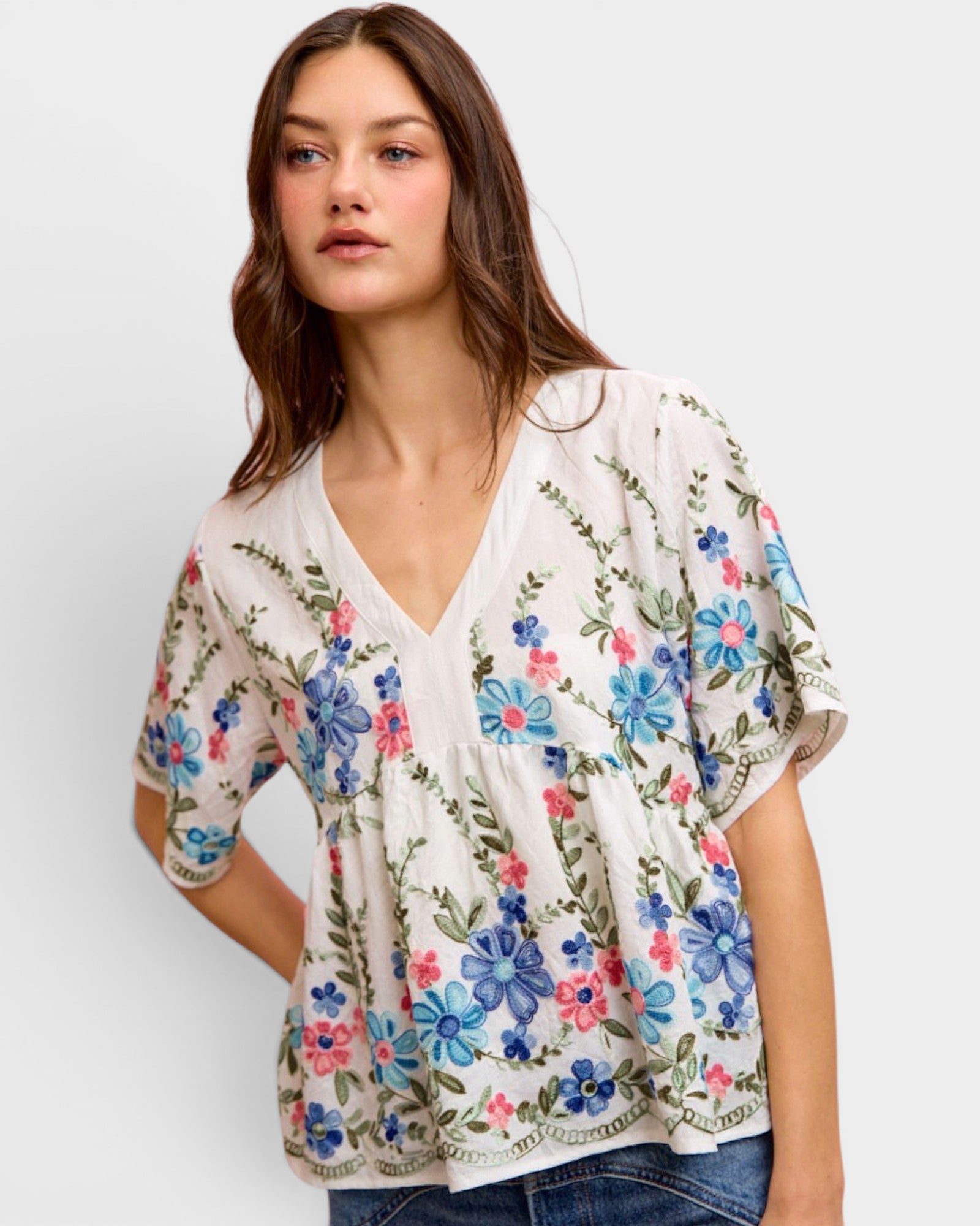 Woman wearing a floral blouse with a plain background