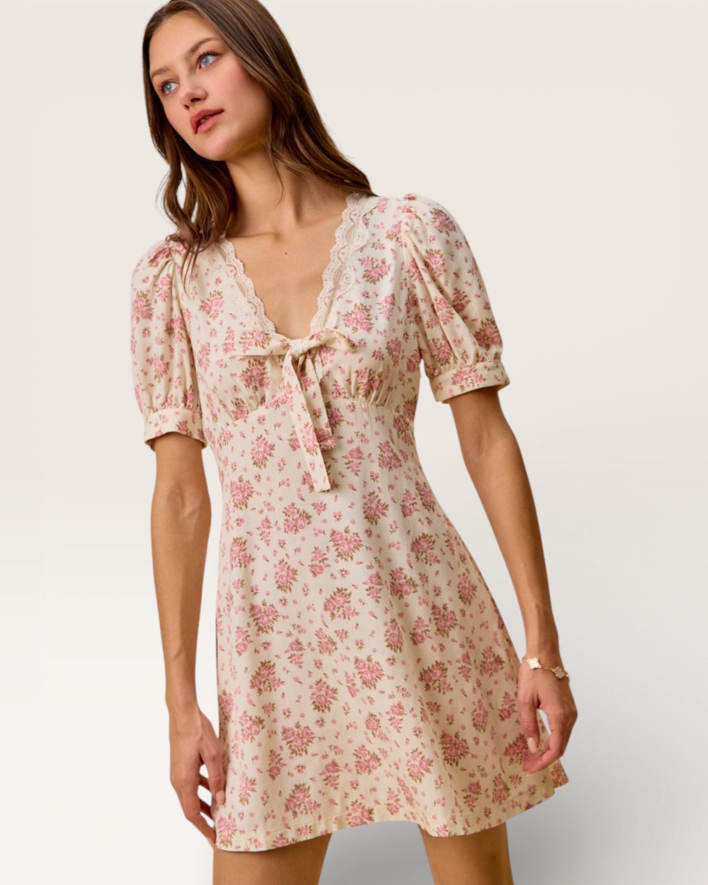 Woman wearing a floral dress on a plain background