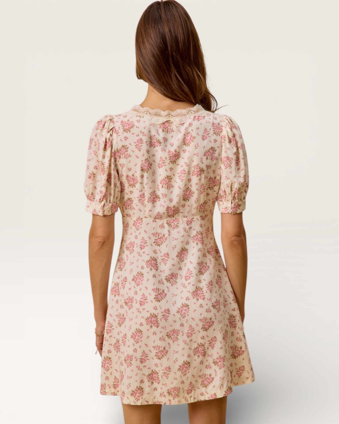 Woman wearing a floral dress on a plain background