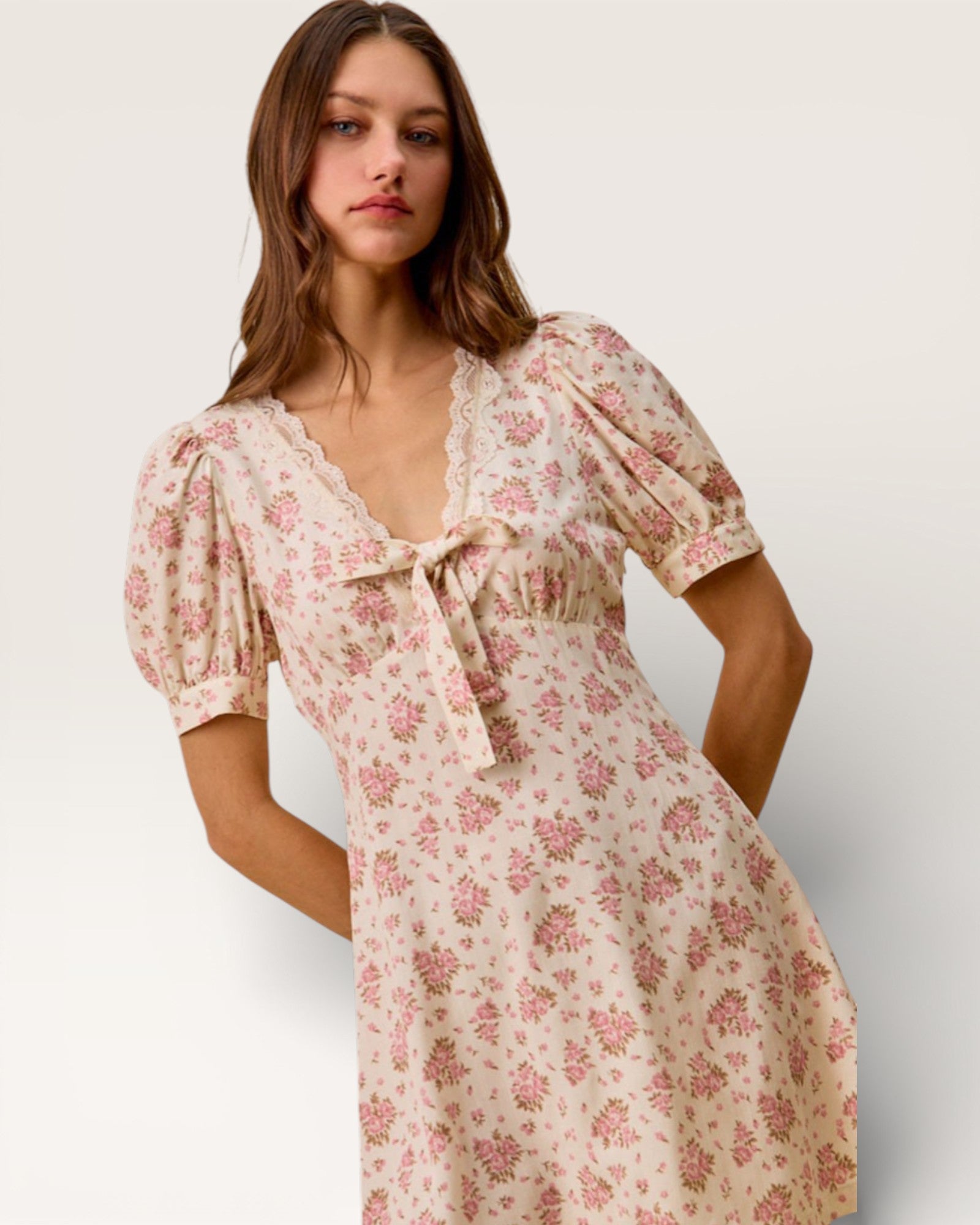 Woman wearing a floral dress on a plain background