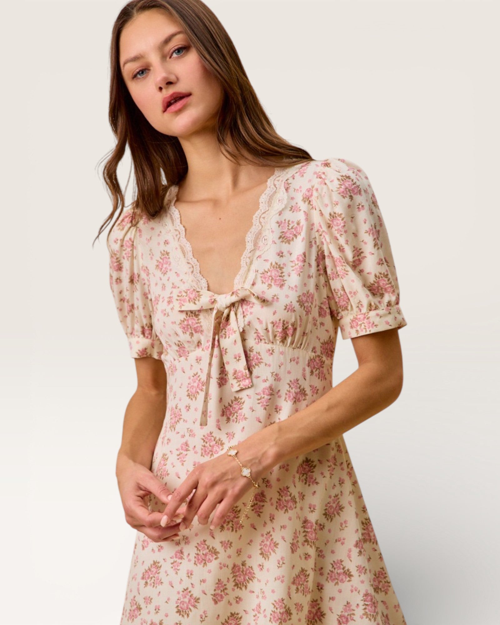 Woman wearing a floral dress on a plain background