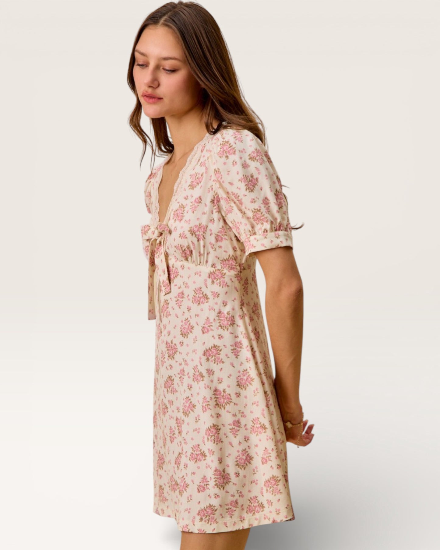 Woman wearing a floral dress on a plain background