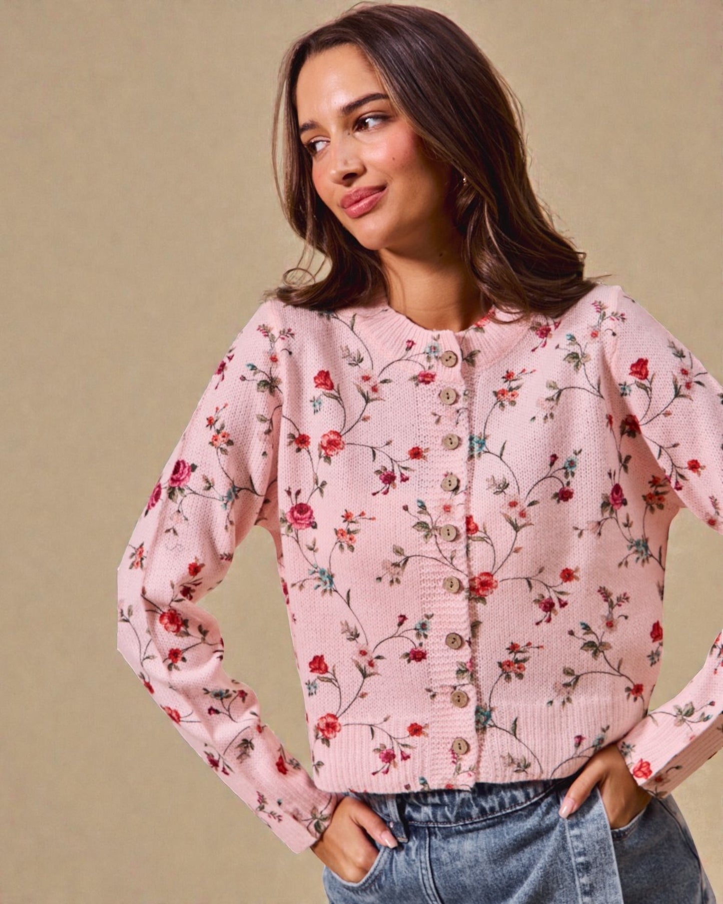 Woman wearing a pink floral blouse against a beige background