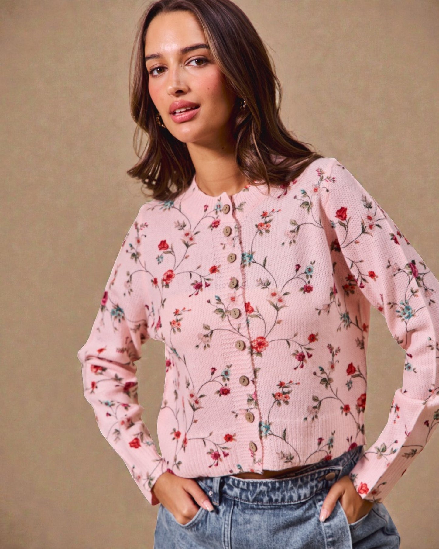 Woman wearing a pink floral blouse against a beige background