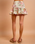 Floral skirt worn by a person on a beige background