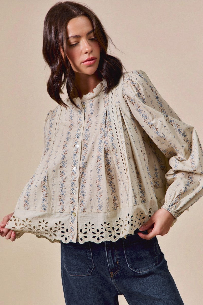 Woman wearing a floral lace blouse with a beige background