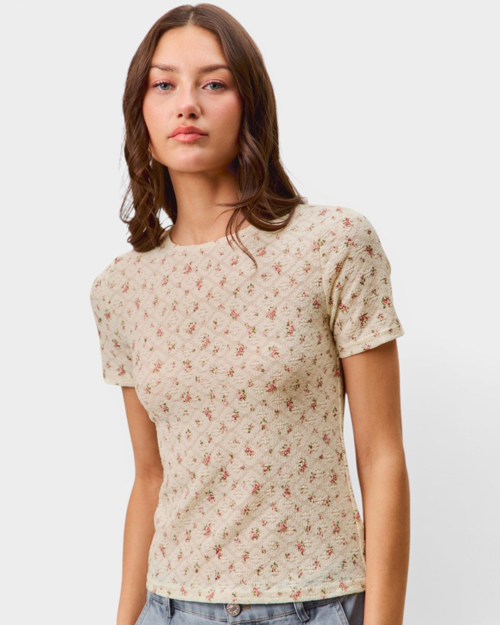 Woman wearing a floral patterned shirt against a plain background