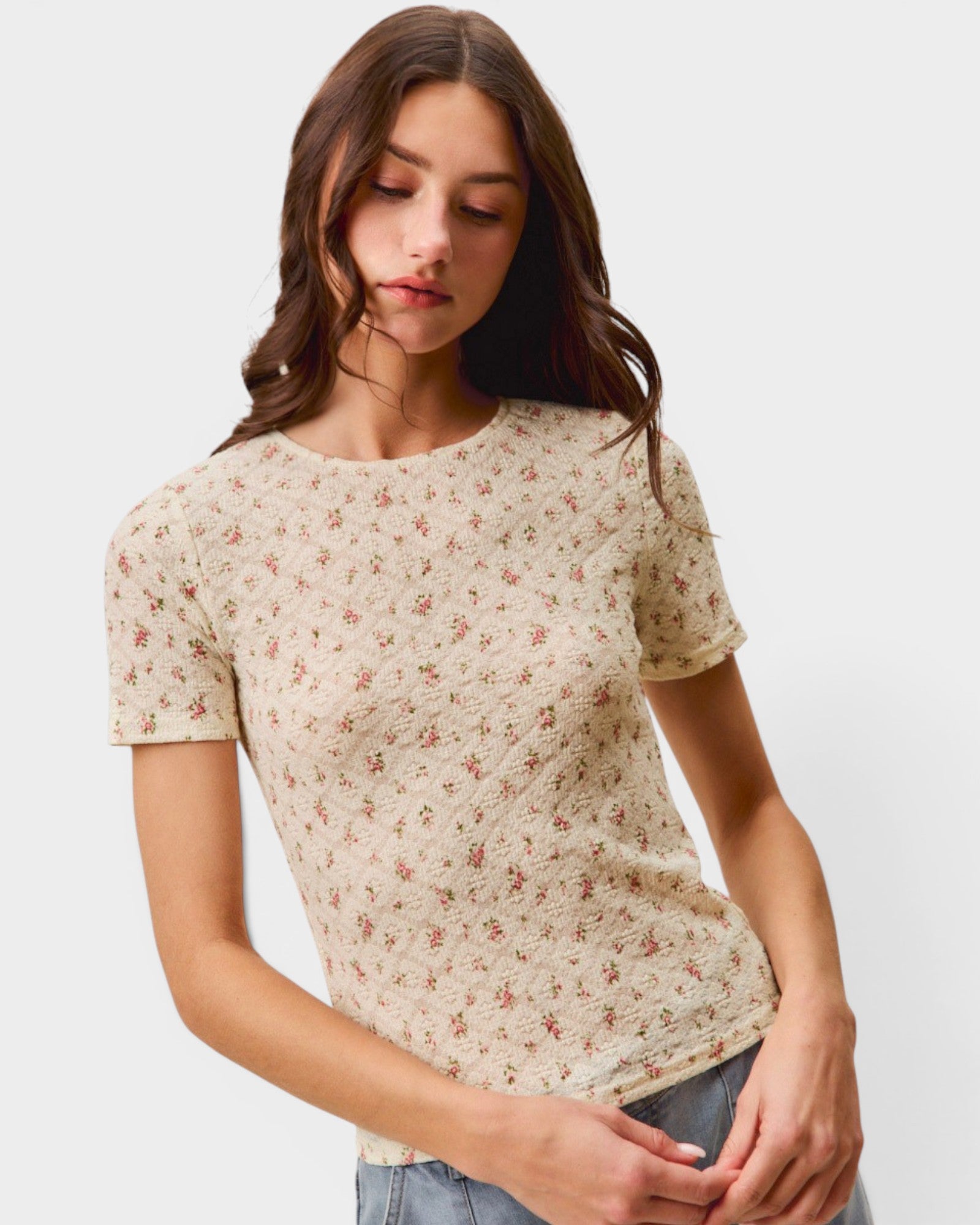 Woman wearing a floral patterned t-shirt against a plain background