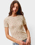 Woman wearing a floral patterned t-shirt against a plain background