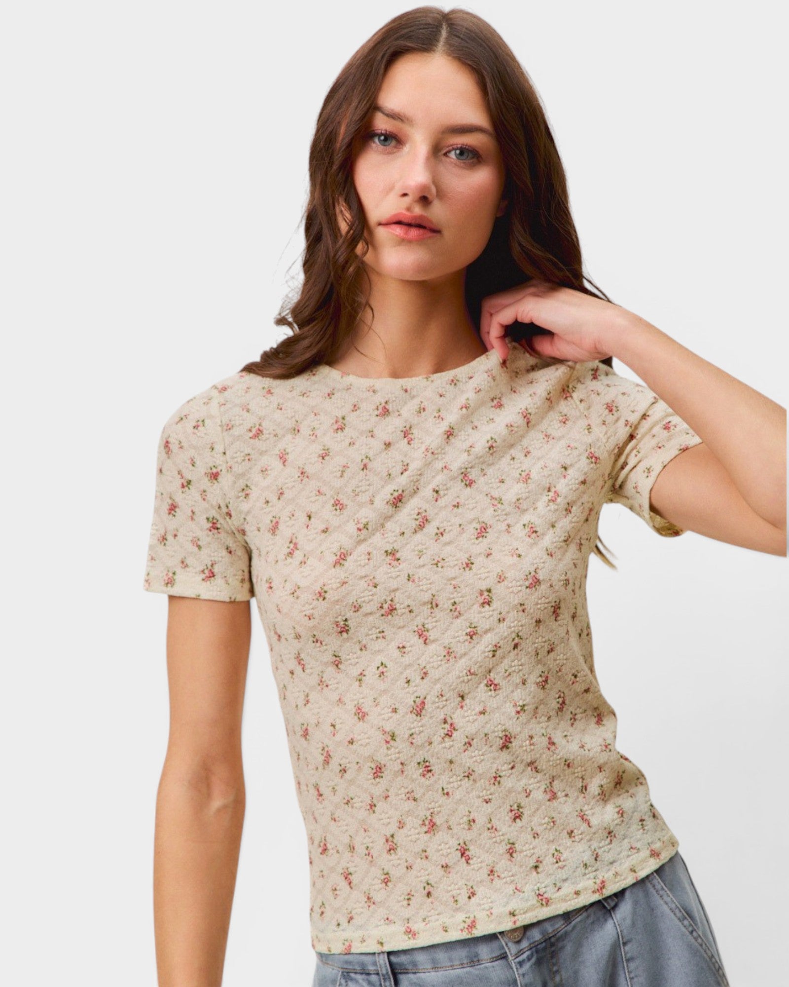 Woman wearing a floral patterned t-shirt against a plain background
