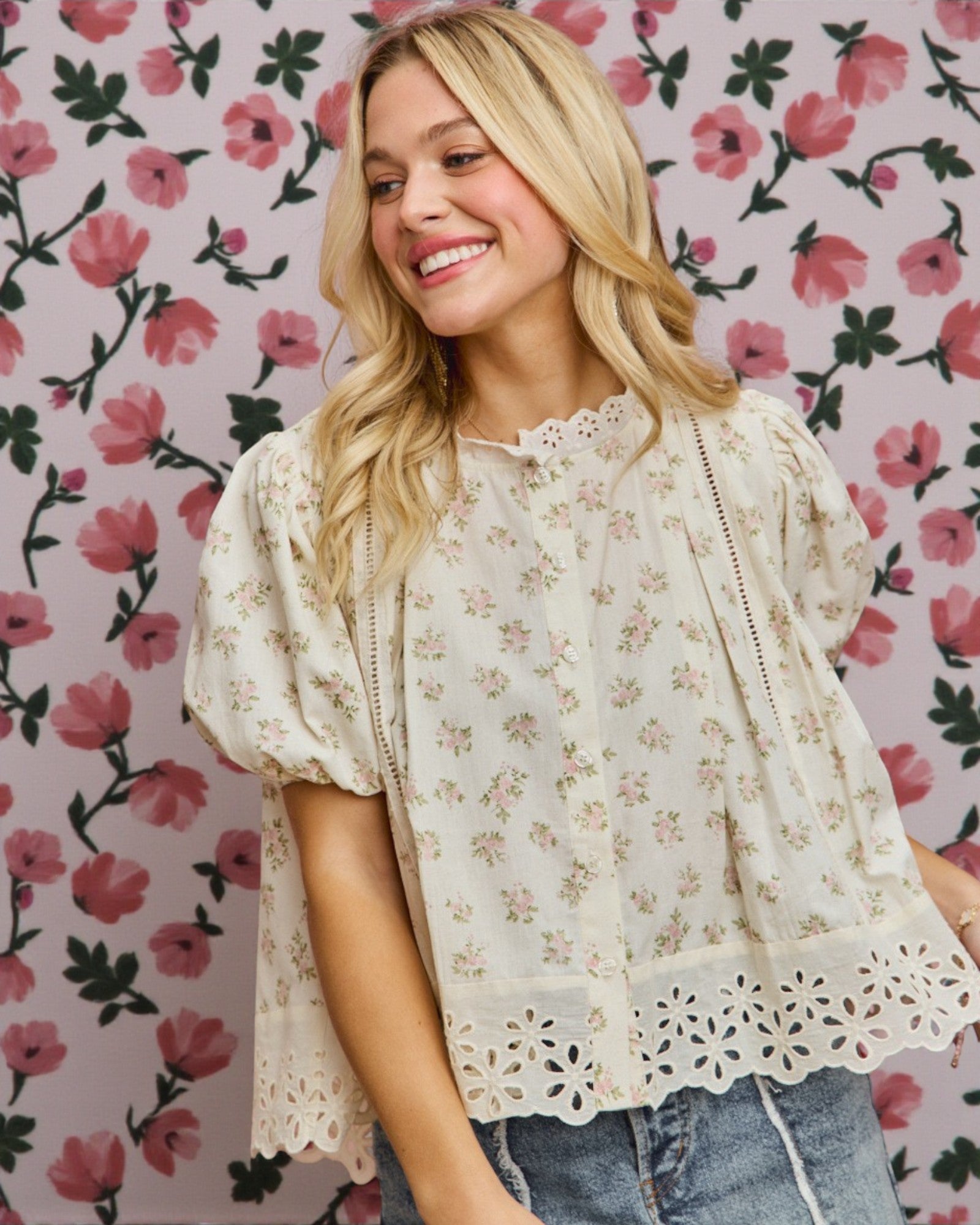 Woman wearing a floral blouse against a floral patterned background
