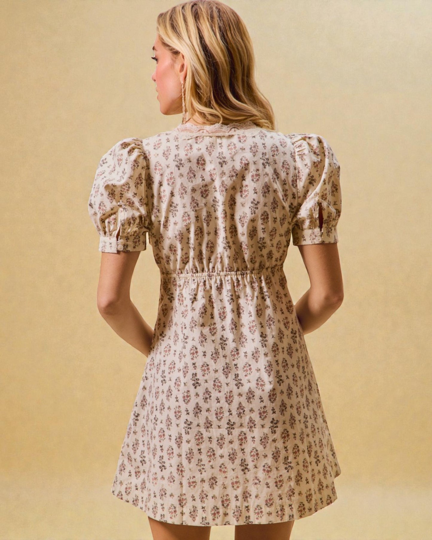 Woman wearing a floral dress against a beige background