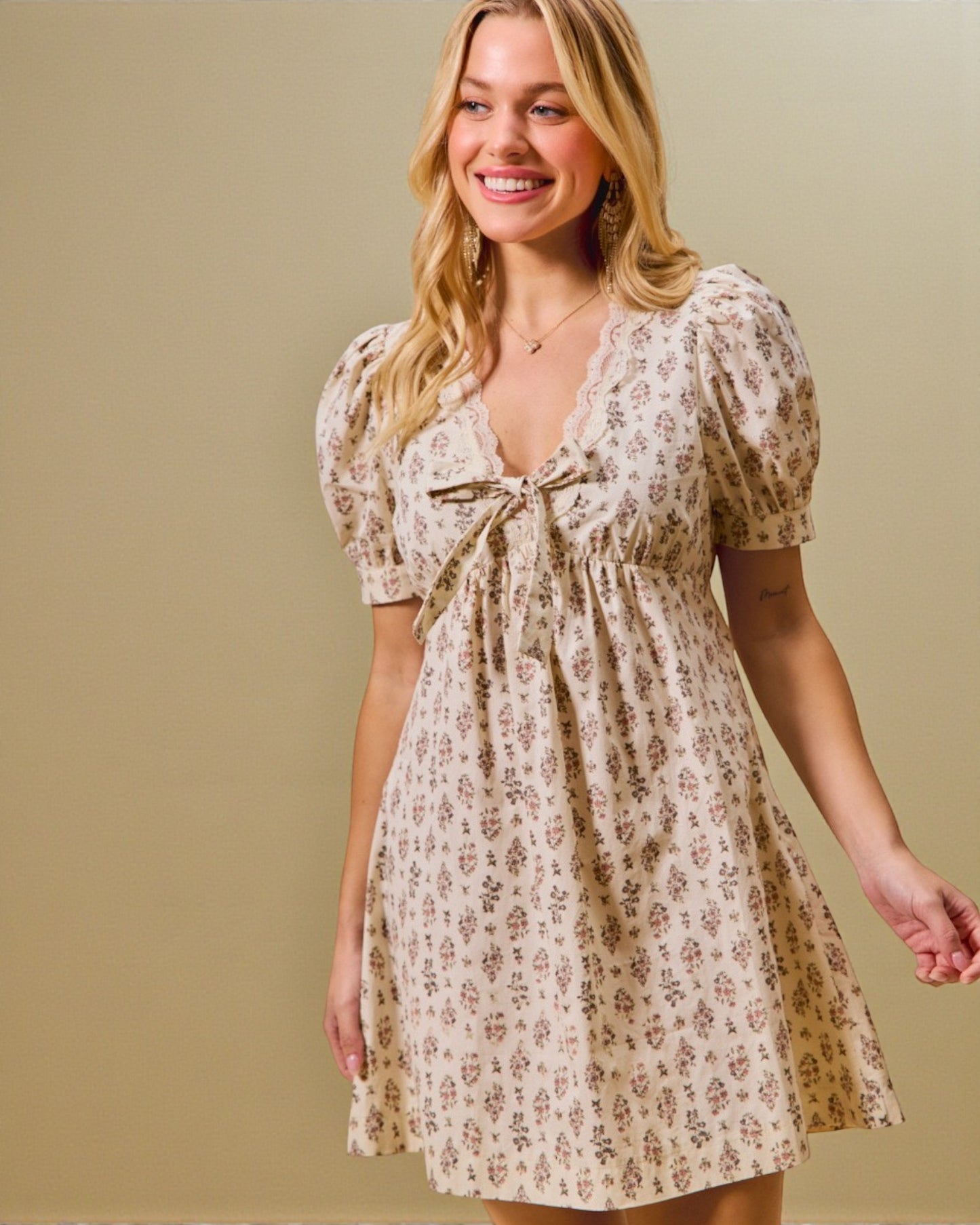 Woman wearing a floral dress against a beige background