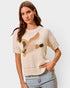 Woman wearing a beige sweater with a fox design on a light gray background