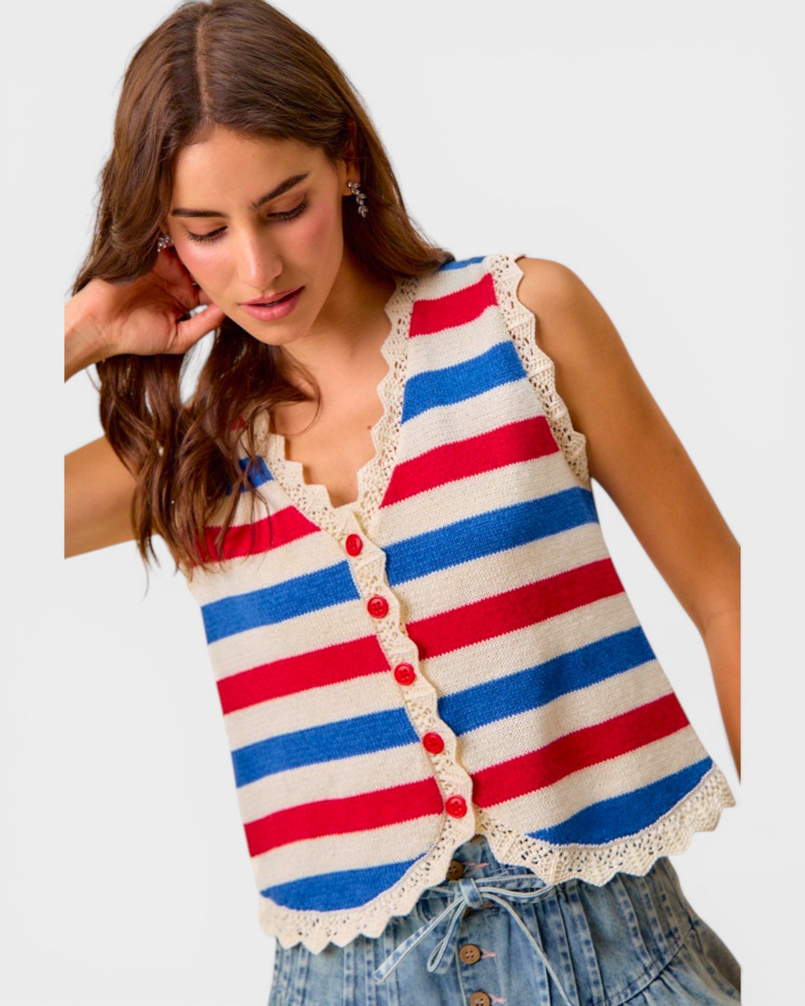 Woman wearing a red, white, and blue striped vest with lace trim on a light gray background