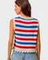 Woman wearing a sleeveless striped top with red, white, and blue colors on a plain background.