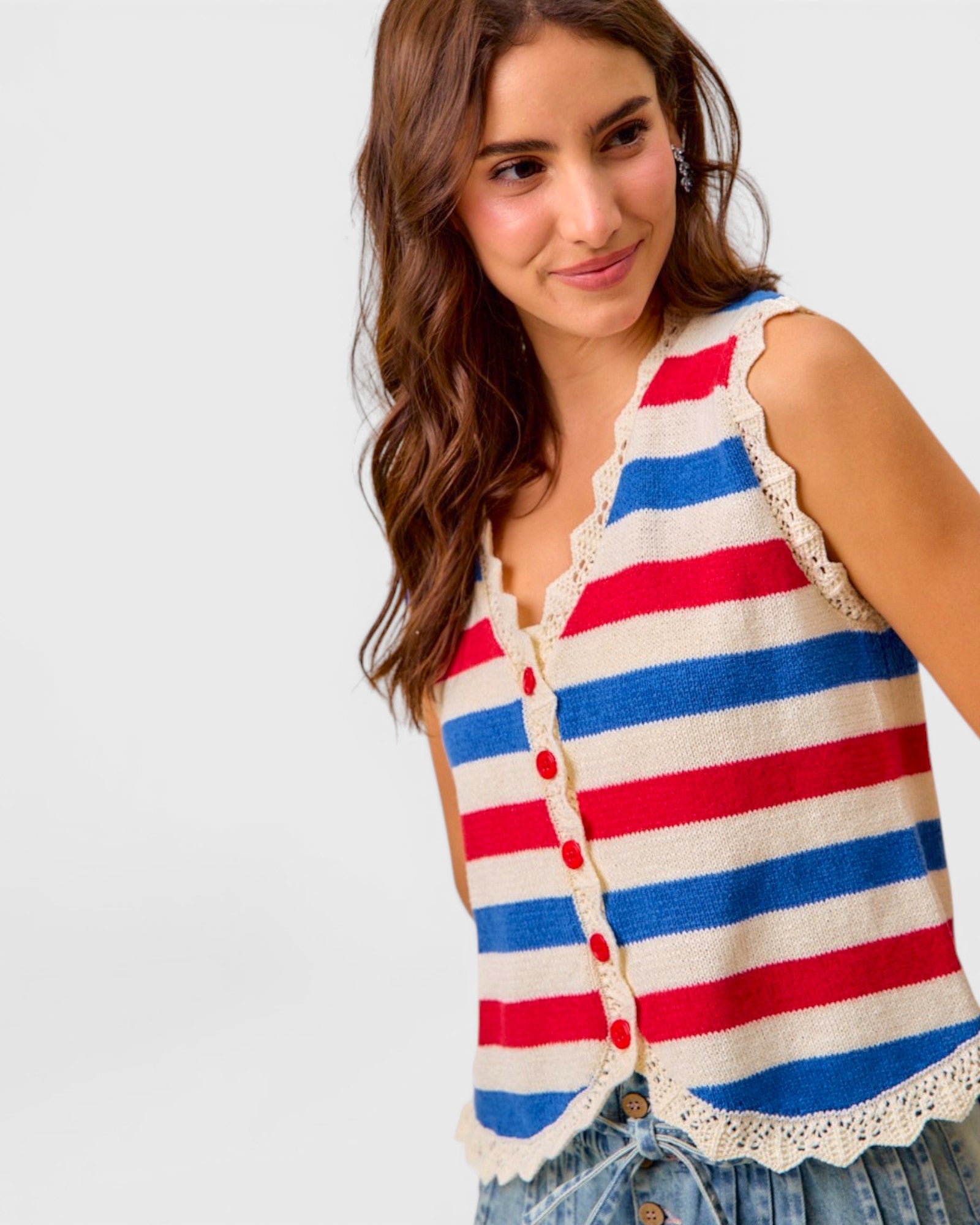 Woman wearing a red, white, and blue striped sleeveless top on a light gray background