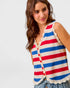 Woman wearing a red, white, and blue striped sleeveless top on a light gray background
