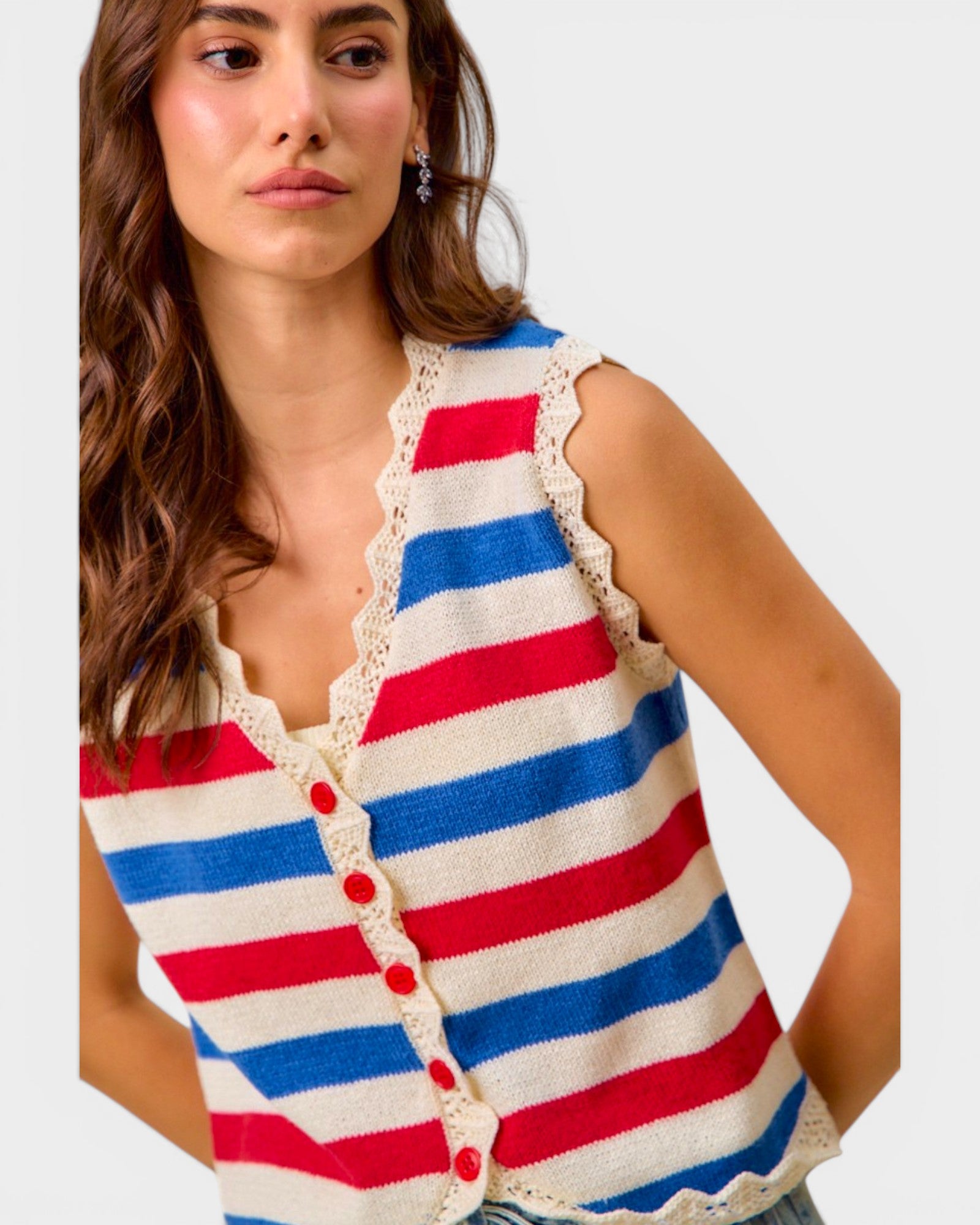 Woman wearing a red, white, and blue striped sleeveless cardigan with lace trim.