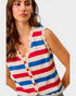 Woman wearing a red, white, and blue striped sleeveless cardigan with lace trim.