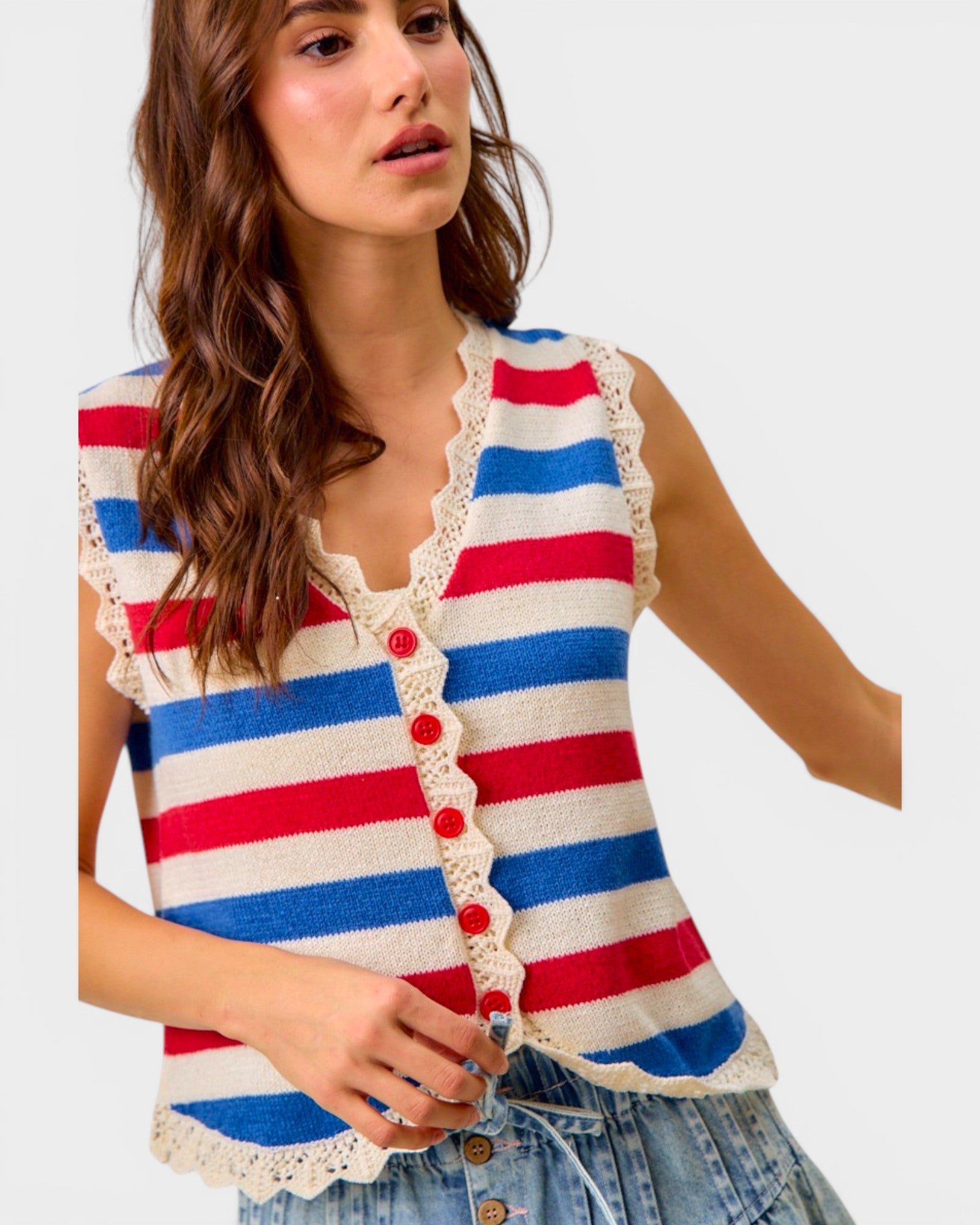 Woman wearing a red, white, and blue striped sleeveless top with lace details.