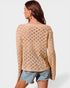 Woman wearing a beige knitted sweater with a white background