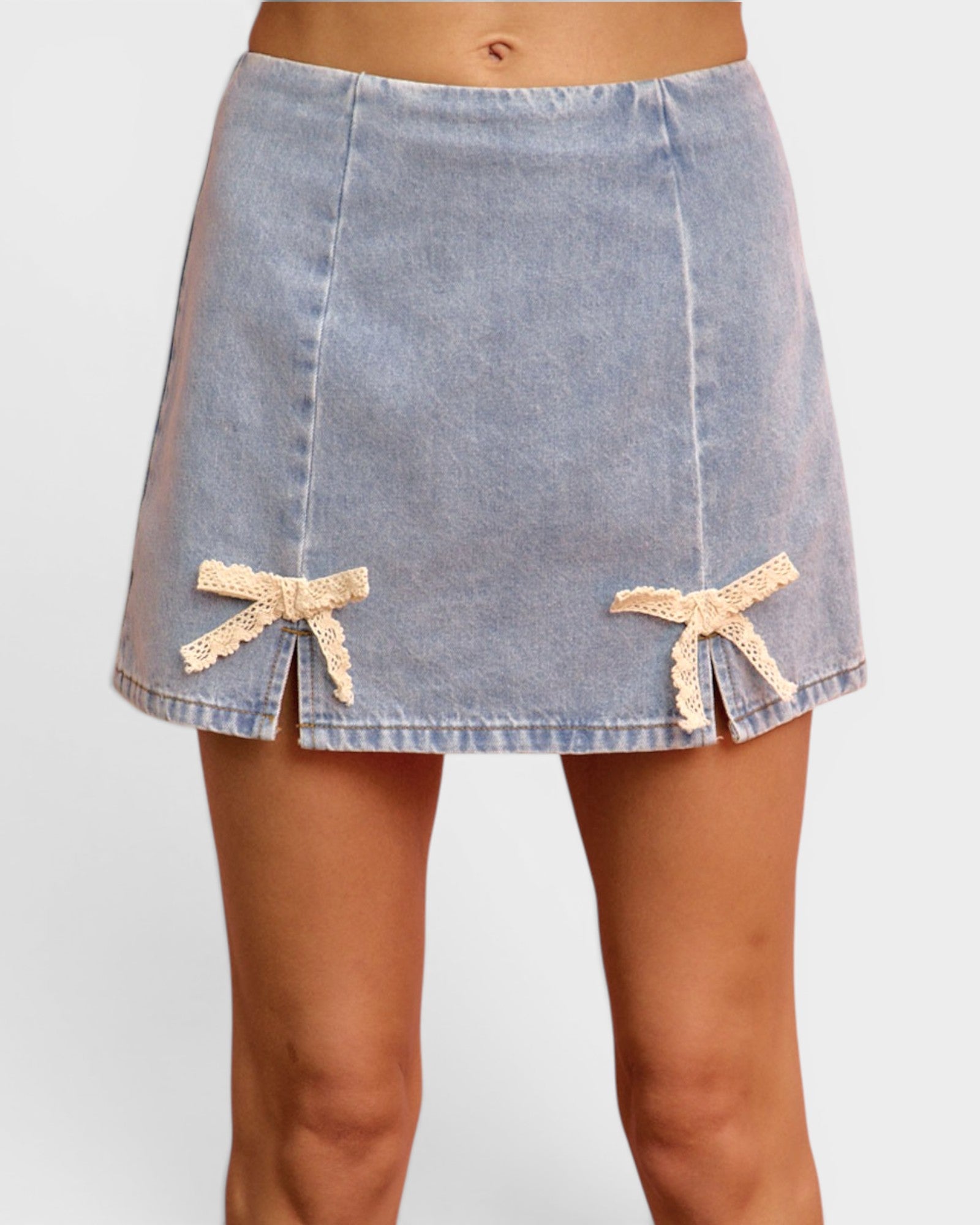 Denim skirt with lace trim on a plain background