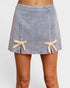 Denim skirt with lace trim on a plain background