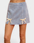 Denim skirt with lace trim on a white background