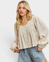 Woman wearing a beige blouse and denim shorts on a white background