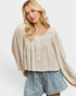 Woman wearing a beige blouse and denim shorts on a white background