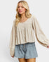 Woman wearing a beige blouse and denim shorts on a white background