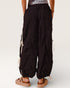 Black wide-leg pants with white drawstrings worn by a person on a plain background