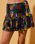 Checkered sequin skirt in purple, green, and gold on a beige background